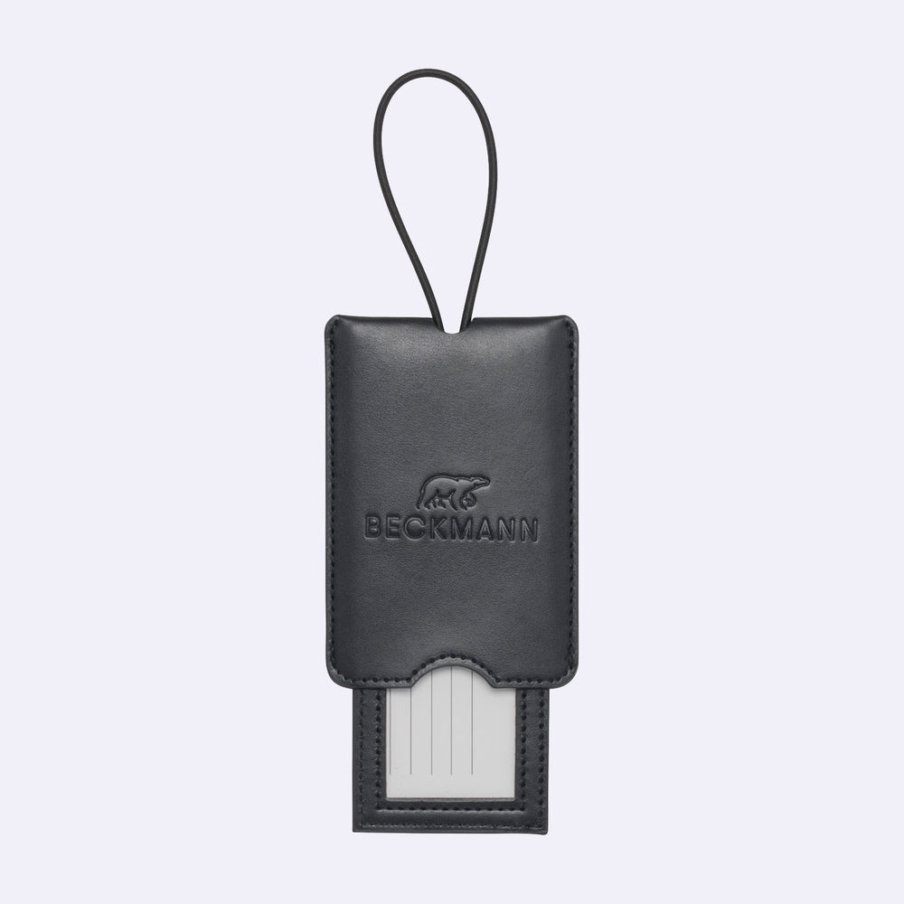 Black leather luggage tag with a visible brand logo