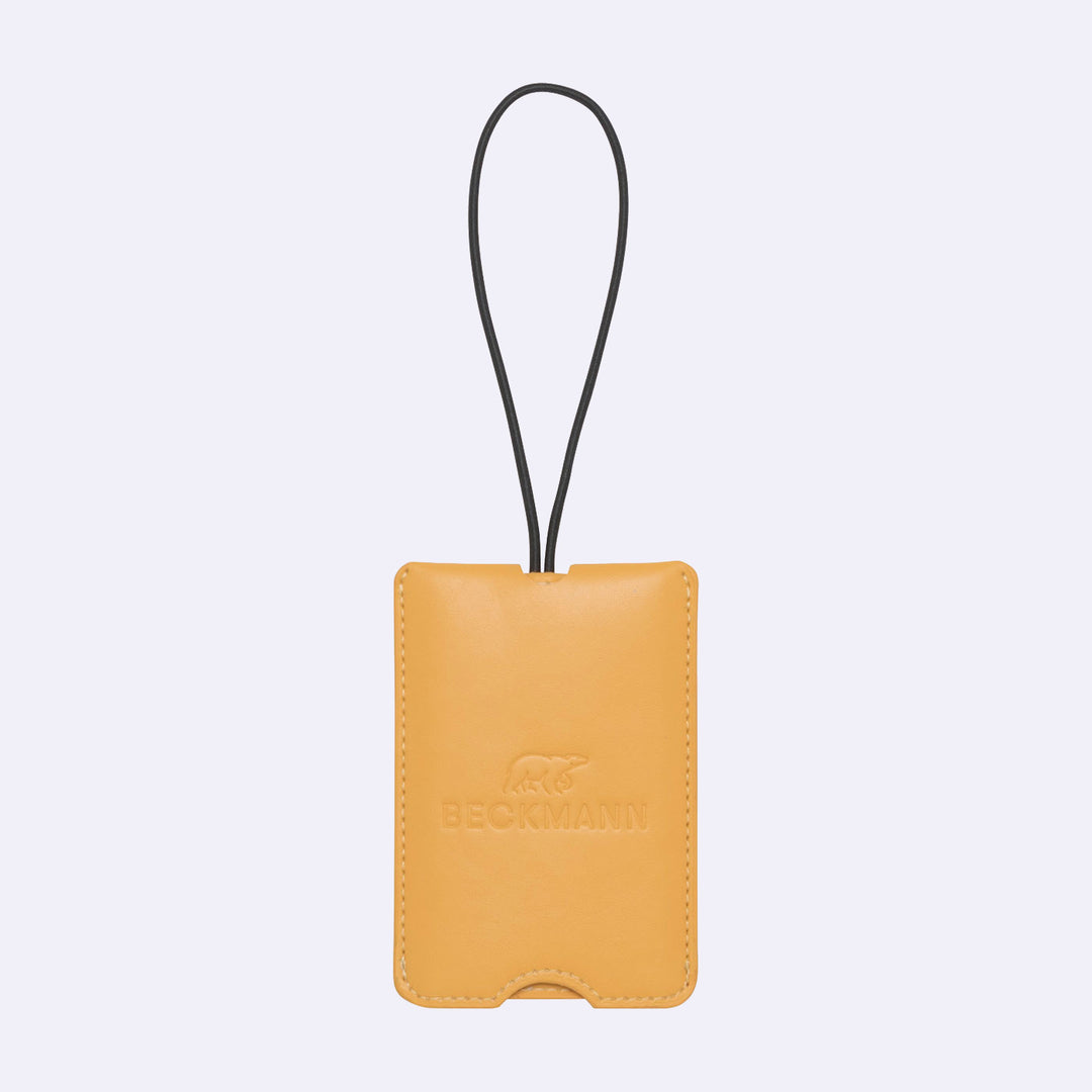 Yellow leather luggage tag with a brand logo
