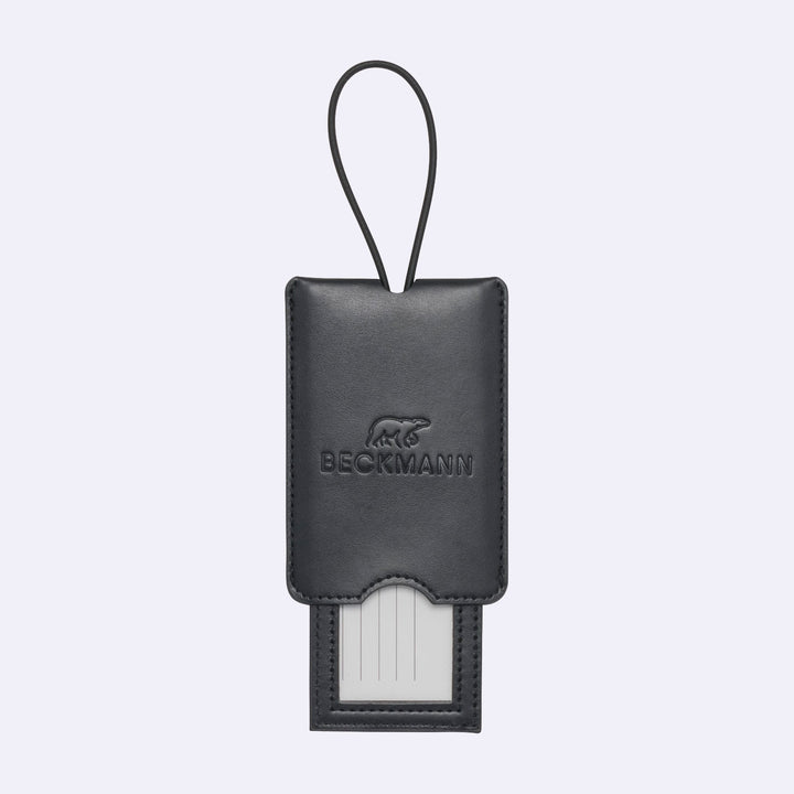 Black leather luggage tag with a visible brand logo